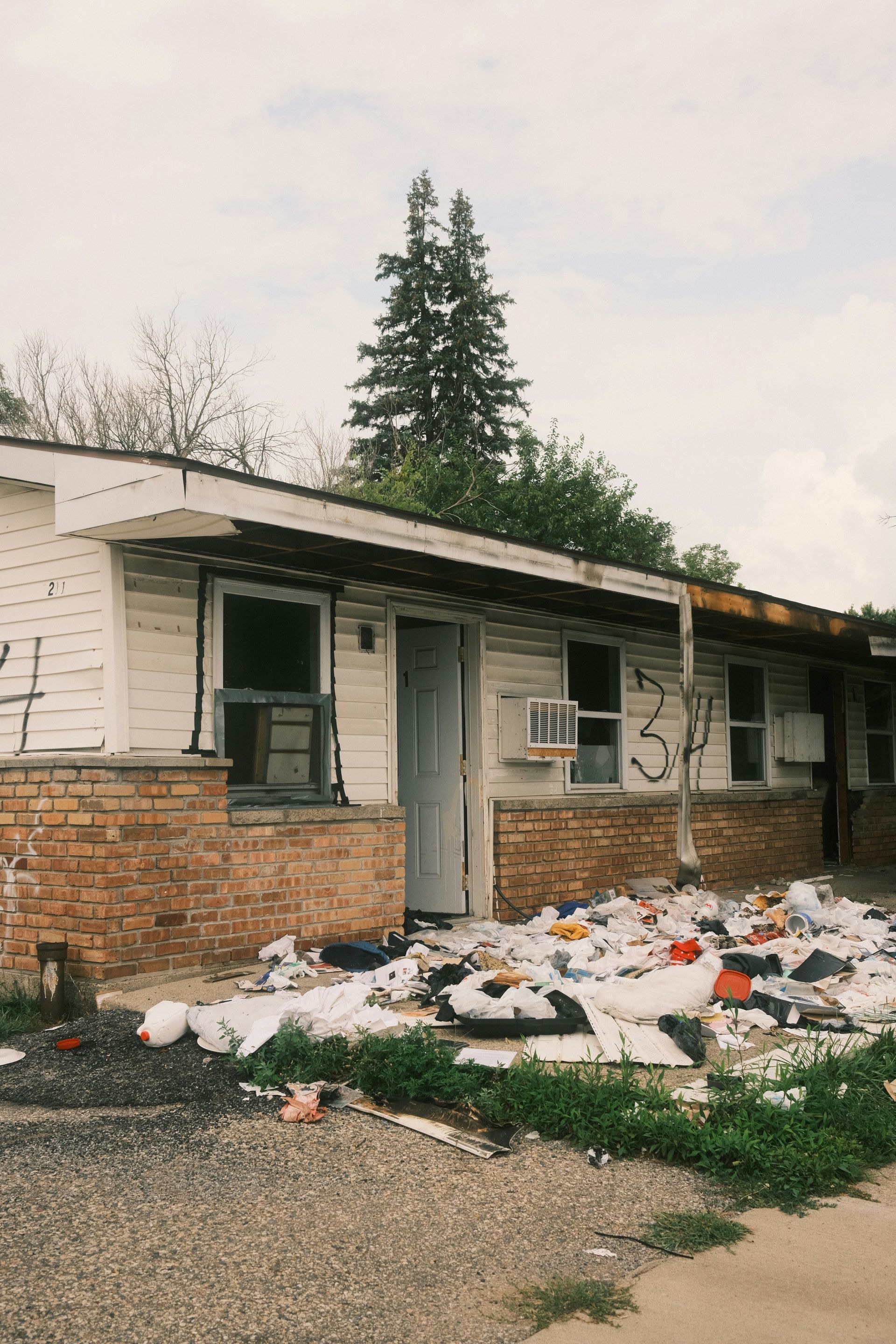 A pile of trash sitting in front of a house